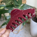 Detail of a large glossy burgundy hair claw clip with a sleek dragon-bone handle design - Extra Large (14cm) / Ancorra Red