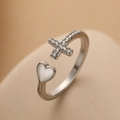 Minimalist silver heart and cross ring with white zircon stones on a beige surface - Adjustable Open / Silver Cross Heart (13663)