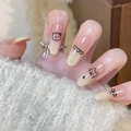Macro shot of nude gradient press-on nails with black hand-drawn bear and heart patterns - Silver Flakes Design Style (BS2125) / Prefabricated Nail Strips (30 Pieces/Sheet)