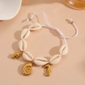 Detail view of beach style shell bracelet with gold starfish and seahorse charms - White Rope Conch Bracelet