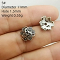 Macro detail of 11mm silver flower bead spacers for DIY jewelry bracelets - Style 5