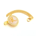 Detail of golden pacifier clip with rhinestone initial R and elegant double link chain - Letter R