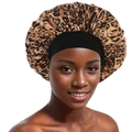 Detail of leopard print satin sleep bonnet with wide elastic black headband on model - One Size / Leopard Print