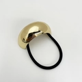 Detailed close-up of a glossy gold geometric metal buckle on a black elastic hair tie - Eco-friendly Style A Gold