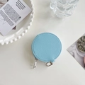 Detailed view of light blue leather round coin purse with silver zipper and pebble texture - Sky Blue