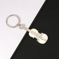 Silver violin-shaped metal keychain with detailed strings on a dual-tone background - Violin