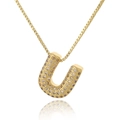Macro view of gold-plated letter U pendant with micro-paved zircon on a box chain - Letter U