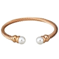 Macro shot of twisted rose gold cable bracelet featuring elegant white pearls on ends - Rose Gold
