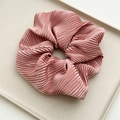 Detail of dusty pink oversized scrunchie with silky pleated texture and soft luster - Pink