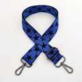 Close-up of blue wide adjustable shoulder strap with black star patterns and metal hooks - Blue Base Black Star Gunmetal Buckle