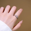 Silver four-leaf clover adjustable ring with sparkling cubic zirconia on model's finger - Adjustable Open / Silver