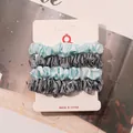 Detail of 4-pack satin scrunchies in light blue and grey on a hanging display card - Sky Blue and Blue Gray