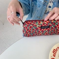 Handheld corduroy pouch with red and yellow floral pattern and smooth black zipper detail - Hong Kong Style