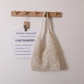 Minimalist cream woven hollow shoulder bag for summer beach vacation hanging on wood hook - Checkered With Inner Bag / Off White