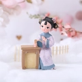 Miniature figurine of a Chinese princess reading at a desk in purple and blue robes - Reading Maiden Figurine