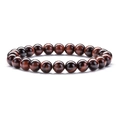 Macro detail of red tiger eye stone bracelet with smooth round beads on white background - Red Tiger Eye