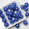Close-up of deep blue iridescent acrylic round beads in a white ceramic dish - Sapphire Blue