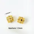 Detail of 8.5mm gold-plated beads with intricate engraving and inlaid cubic zirconia - Style 07 Geometric Polyhedron-Aperture 1.5mm