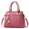 Pink lychee texture leather handbag with floral tassel pendant and adjustable shoulder strap - Dusty Pink