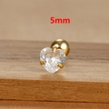 Macro shot of 5mm heart-cut zircon stud earring with gold finish on wooden texture - 1 Piece / 5mm / Gold