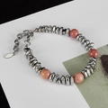 Close-up of pink volcanic stone and titanium steel bamboo bracelet with S.steel tag - S2009 Silver Chips Natural Pink Stone Bracelet