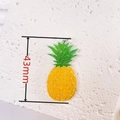 Macro detail of 43mm acrylic pineapple charm with yellow glitter and green leaves - Pineapple