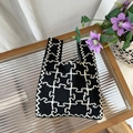 Detail of black and white knitted tote bag with geometric pattern on glass table - Geometric Line Black