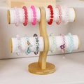 Two-tier solid wood jewelry display stand holding various colorful beaded bracelets - ZM008 White PU 2-Tier Bracelet Holder