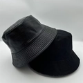 Close-up of black bucket hats showing smooth canvas and textured leather-like materials - Double Black Texture 2-Piece Set (24)