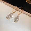 Close-up of golden U-shaped earrings featuring natural white baroque pearl pendants - Gold U-shaped Ear Hook Baroque Pearl