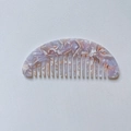 Macro detail of half-round hair comb with pink purple marble texture in cellulose acetate - Grey Purple