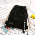 Black canvas drawstring backpack with cream cotton ropes and fashion logo tag - Black
