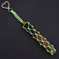 Macro detail of hand-woven fluorescent green lipstick holder with silver heart clip - Green