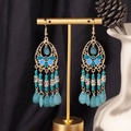 Detail of bohemian drop earrings with turquoise beads and gold tassels on display - S4293 Blue Water Drop Fringe Earrings