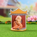 Cute little monk figurine in orange robe on golden base with red temple background - 1034-23F Carefree Soul Set