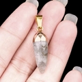 Handheld gray natural stone bullet pendant with a gold-plated cap and tapered facets - Labradorite
