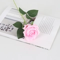 Single pink velvet artificial rose with green stem on a white minimalist desk - Silk Pink