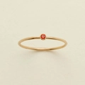 Minimalist gold titanium ring featuring a round orange gemstone in a bezel setting - US 7 / July/Red Zirconia