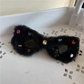 Black furry sunglasses with colorful rhinestones, funny party eyewear detail view. - Black