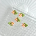 Cinq breloques muguet en résine rose avec feuilles vertes sur verre ondulé - Orange Fluorescent