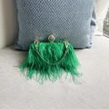 Detail view of emerald green ostrich feathers and gold metal handle with crystal ring - Green