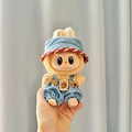 Miniature doll wearing blue denim overalls and cowboy hat for Labubu doll figure - Blue And Red Trimmed Cowboy Hat + Cowboy Biscuit Bear Keychain / First And Second Generation Keychains Are Compatible With La Cloth Dolls. Dolls Not Included.