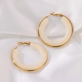 Detail of chunky C-shape hoop earrings with gold metal frame and cream resin on silk fabric - White