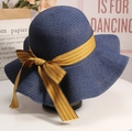 Women's wide brim straw sun hat in navy blue with a striped ribbon bow decoration - M (56-58cm) / Navy Blue
