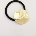 Minimalist black elastic hair tie with a textured gold metallic hammer-effect round ornament - Round Embossed Gold