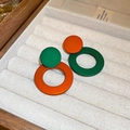 Minimalist matte green and orange hoop earrings displayed in a velvet jewelry box - Contrast Color Round Style / Orange-Green