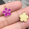 Purple flower pendant with gold trim shown on fingers showing front and back - 1Pc Purple Flower 14x17mm