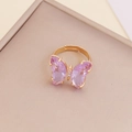 Close-up of golden butterfly ring featuring large purple crystal wings and zircon inlay - Light Purple
