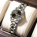 Detailed close-up of a two-tone steel quartz watch with black dial in a beige leather box - Gold Band Black Dial Women
