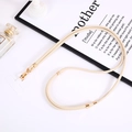 Detail of beige braided nylon phone lanyard with gold metal buckle and transparent patch - Adjustable Nylon Crossbody Chain (K4215) / Off-white